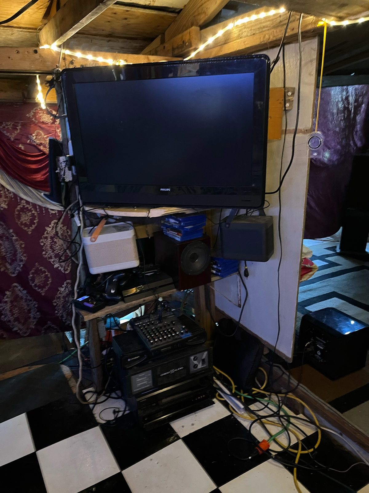 Bedroom entertainment center with Philips TV, audio mixer and speakers